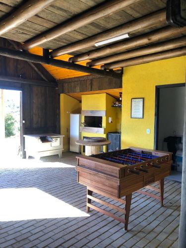 a large ping pong table in the middle of a patio at Cabanas Recanto do Rancho - Rancho Queimado in Rancho Queimado