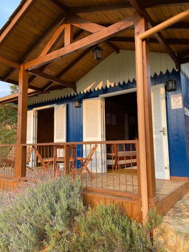 a blue and white house with a wooden porch at Cabanas Recanto do Rancho - Rancho Queimado in Rancho Queimado