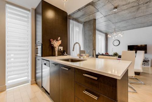 a kitchen with a sink and a counter top at Les Immeubles Charlevoix - Le 760206 in Quebec City