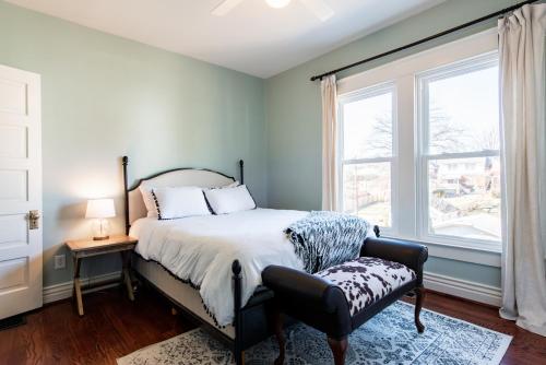 a bedroom with a bed and a chair and a window at Luxe Highlands Home! King BR~Fire Pit~Yard Games in Louisville
