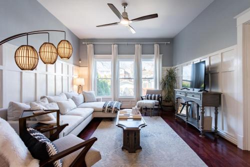 a living room with a couch and a tv at Luxe Highlands Home! King BR~Fire Pit~Yard Games in Louisville