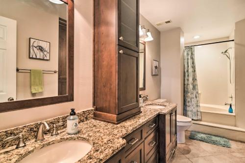 a bathroom with two sinks and a toilet at St Pete Condo with Private Lanai and Community Pool! in St Petersburg