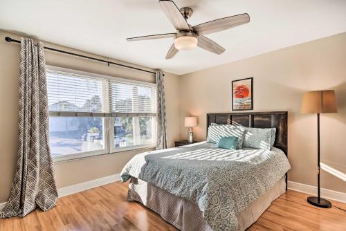 a bedroom with a bed and a ceiling fan at St Pete Condo with Private Lanai and Community Pool! in St Petersburg