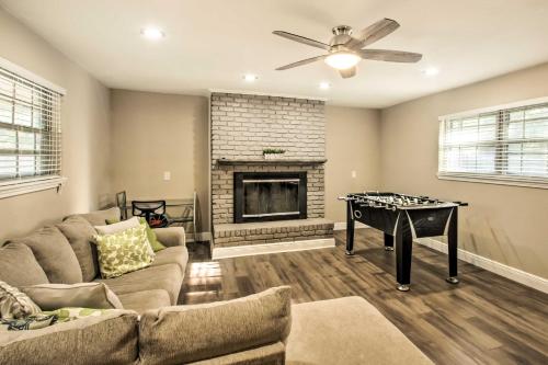 a living room with a couch and a game table at Relaxing Pensacola Getaway with Volleyball Net! in Pensacola