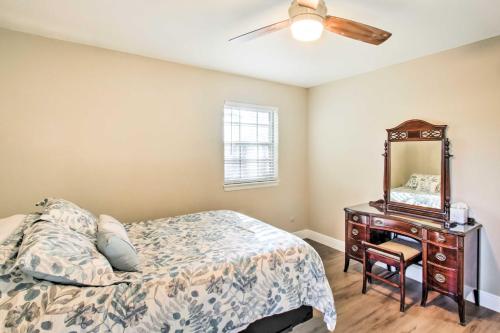 a bedroom with a bed and a dresser with a mirror at Relaxing Pensacola Getaway with Volleyball Net! in Pensacola