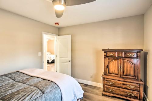a bedroom with a bed and a wooden dresser at Relaxing Pensacola Getaway with Volleyball Net! in Pensacola