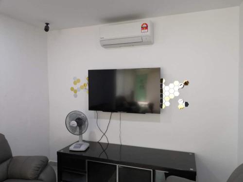 a living room with a flat screen tv on a wall at Zing Motel in Butterworth