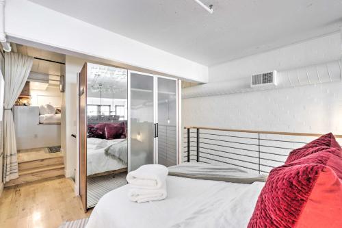 a bedroom with a bed with red blankets on it at Chic SLC Downtown Studio Loft Walk to Shops in Salt Lake City