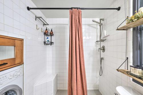 a shower curtain in a bathroom with a washing machine at Chic SLC Downtown Studio Loft Walk to Shops in Salt Lake City
