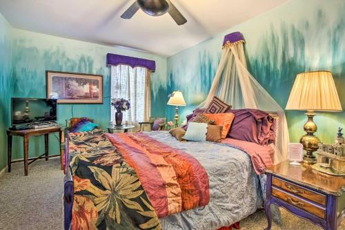 a bedroom with a bed with a canopy at Artsy Getaway about 8 Miles to Downtown Kansas City! in Independence
