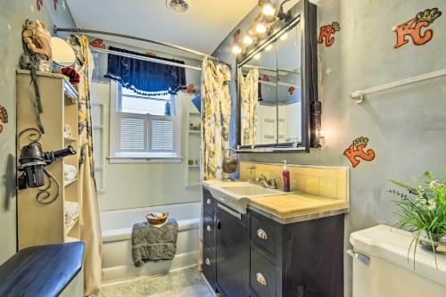 a bathroom with a sink and a tub and a shower at Artsy Getaway about 8 Miles to Downtown Kansas City! in Independence