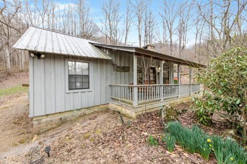 a small white house with a porch at Hidden Creek Cabin in Franklin