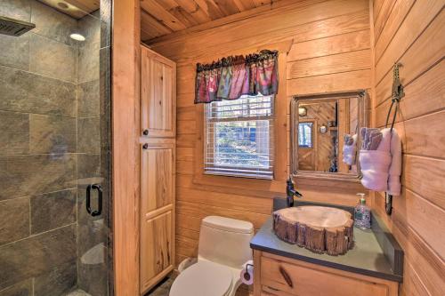 a bathroom with a shower and a toilet and a sink at Helen Cabin with Deck and Hot Tub Less Than half Mi to Main St in Helen