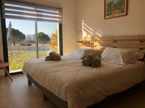 ein Schlafzimmer mit einem Bett mit zwei Hüten darauf in der Unterkunft La Petite Reine in Villes-sur-Auzon