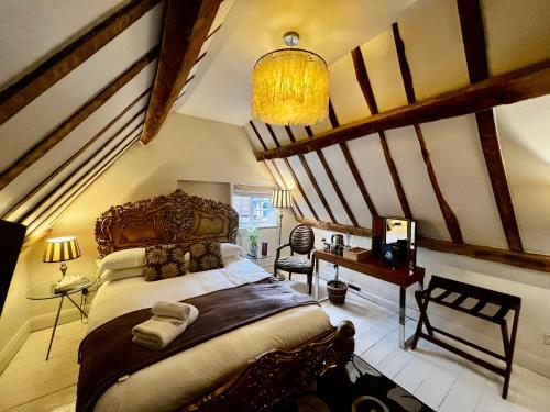 a bedroom with a large bed and a staircase at Miller of Mansfield in Goring