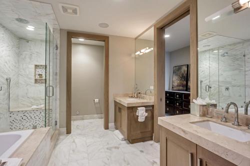 a bathroom with a tub and a sink and a shower at Stein Eriksen Residences in Park City