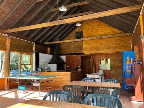 eine Küche und ein Esszimmer mit Tischen und Stühlen in der Unterkunft Portal del Manzano in Villa La Angostura