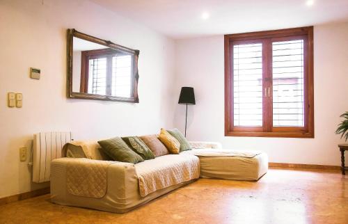 a living room with a couch and a mirror at N28 in Xàtiva