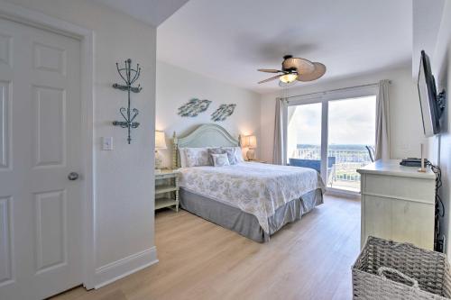 a bedroom with a bed and a large window at Comfy PCB Condo with View and Private Beach Access! in Panama City Beach