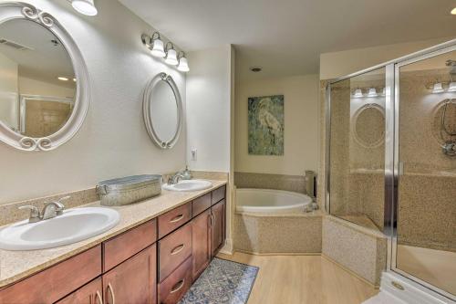 a bathroom with two sinks and a shower and a tub at Comfy PCB Condo with View and Private Beach Access! in Panama City Beach