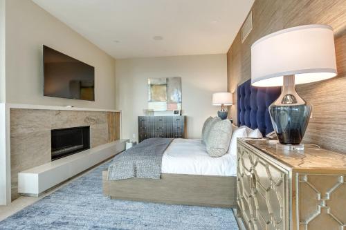 a bedroom with a large bed and a fireplace at Stein Eriksen Residences in Park City