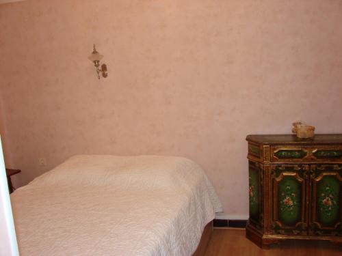 a bedroom with a bed and a nightstand with a white bed at ACCI Cannes Old City in Cannes