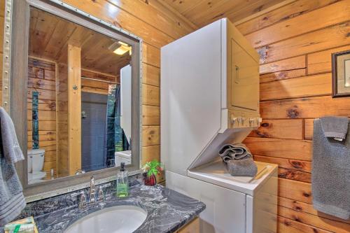 a bathroom with a sink and a mirror at Gatlinburg Cabin with Pool Table and Hot Tub! in Gatlinburg