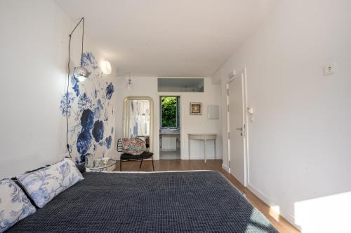 a bedroom with a bed with a blue and white wall at finca dos Mares in Ferrol
