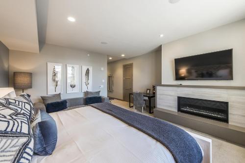 a bedroom with a large bed and a fireplace at Stein Eriksen Residences in Park City