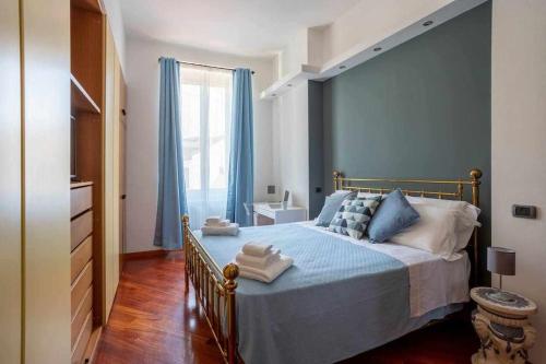 a bedroom with a bed with blue walls and a window at Milano City Apartments-Porta Venezia-Luxury Apartment in Milan