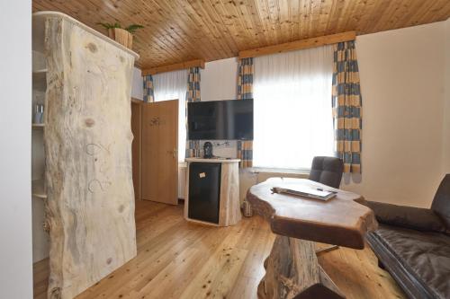 a living room with a couch and a table at Xeis NeSt in Admont