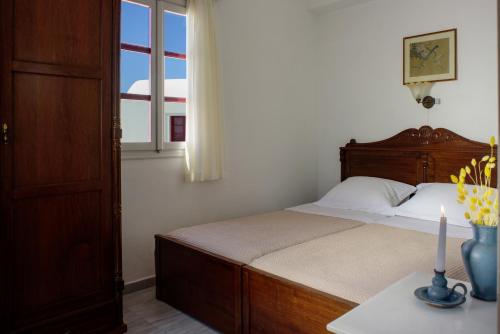 a bedroom with a bed and a window at Nikos Villas in Oia