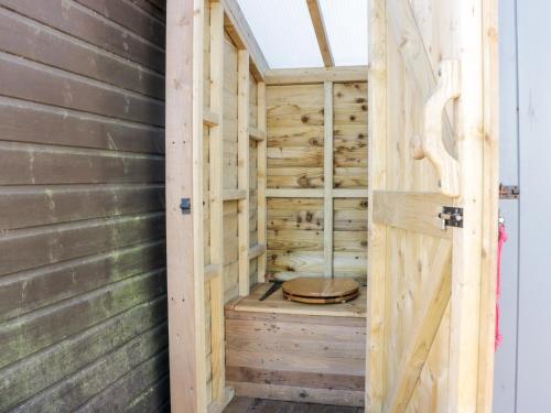 an empty sauna with a wooden door at Ketburn Shepherds Hut at Balnab Farm in Newton Stewart