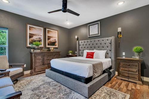 a bedroom with a bed with a red pillow on it at Give Us This Day Chalet in Hollister