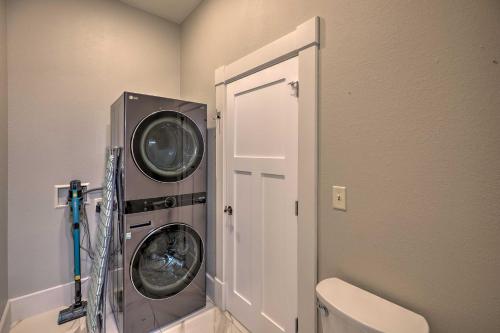 a laundry room with a washing machine and a door at Regal River Retreat in the Heart of Yankton! in Yankton