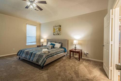 a bedroom with a bed and a ceiling fan at New Beautiful 4/BR Vacation Home in Katy