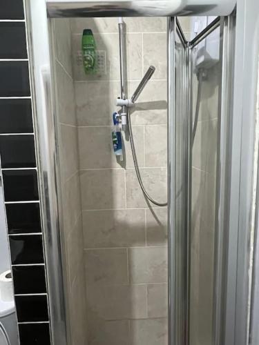 a shower with a glass door in a bathroom at 001- Lovely 3-bedroom very close to Oxford Street in London