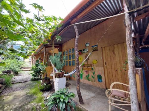 an outside view of a house with plants at Cabañas Maná in San Juan La Laguna