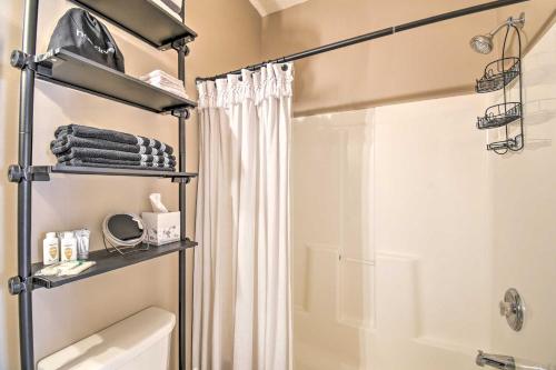 a bathroom with a shower and a white shower curtain at Updated Barefoot Resort Condo On-Site Golf! in North Myrtle Beach
