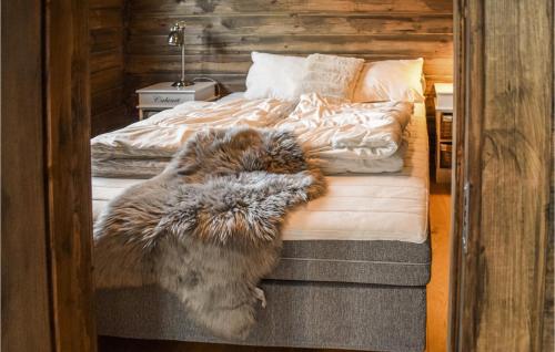 a dog laying on a bed in a bedroom at Gorgeous Home In Kongsberg With Sauna in Kongsberg