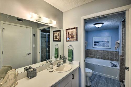 a bathroom with a sink and a toilet and a tub at Oceanfront Condo Rental Near Daytona Speedway in Ormond Beach