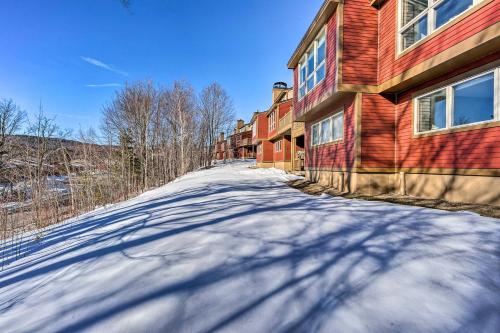 a snow covered road in front of a building at Idyllic Mount Snow Condo with View and Amenities! in West Dover