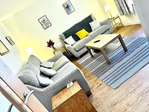 a living room with a couch and a table at Central Spacious 2 Bed 2 Bath, Free WiFi & Parking, Park View in Orkney