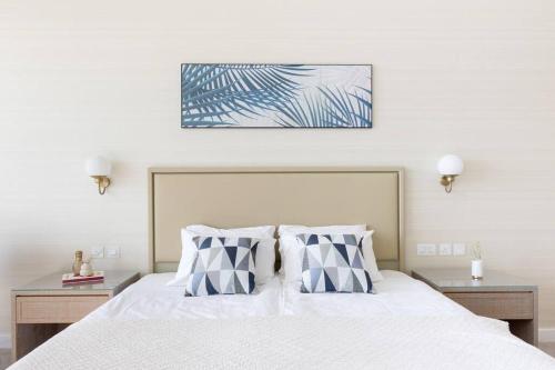 a bedroom with a white bed with two pillows at Palm Tower St. Regis Amazing view high-end Studio in Dubai