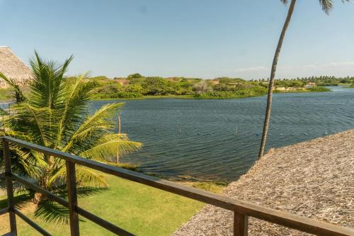 a view of a body of water with a fence at Casa na Lagoa in Paracuru