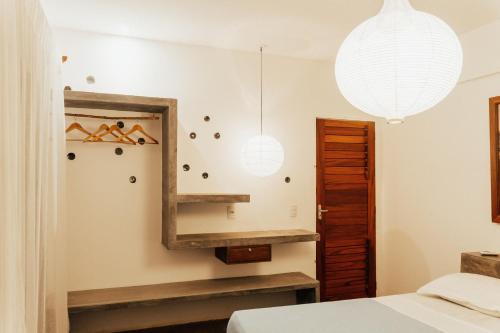 a bedroom with a mirror and a bed at Casa na Lagoa in Paracuru