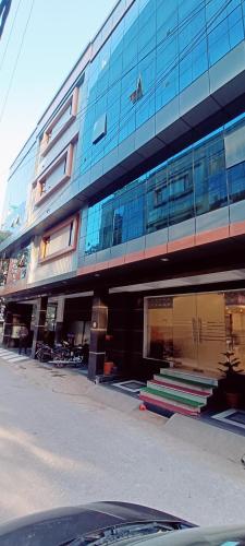 a large glass building with stairs in front of it at Mayda Inn- A Boutique Hotel in New Delhi