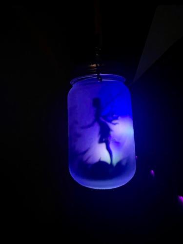 a blue mason jar with a picture of a woman at B&B Corte sul Naviglio CIN I T 0 1 5 0 7 0 C 1 3 X U I L Q C V in Cernusco sul Naviglio