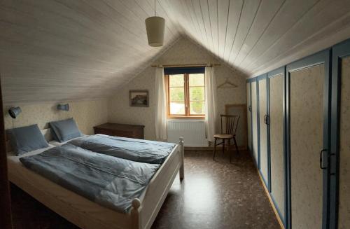 ein Schlafzimmer mit einem großen Bett im Dachgeschoss in der Unterkunft Runeholm in Vimmerby