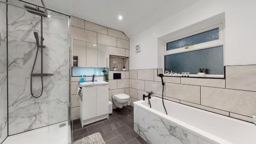 a bathroom with a shower and a toilet at Redwood in Longton